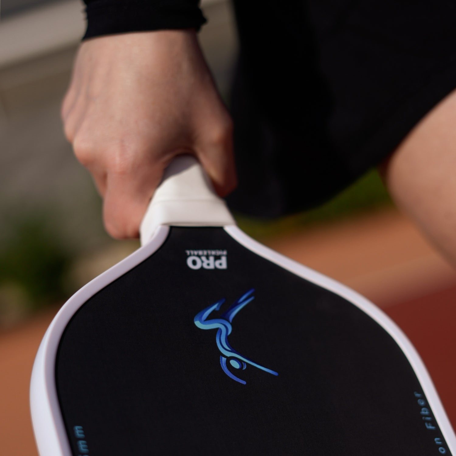 Close-up of JoyExercise MEET pickleball paddle held in hand – showing thermoformed unibody design for controlled power, precision, and durability.