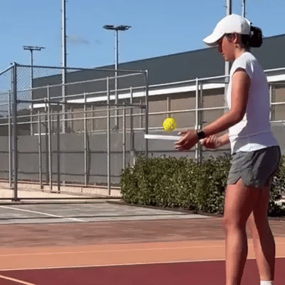 Female pickleball player hitting drop shot with JoyExercise MEET paddle – 16 mm polypropylene core ensures vibration dampening, soft touch, strong drive, and precision control on court.