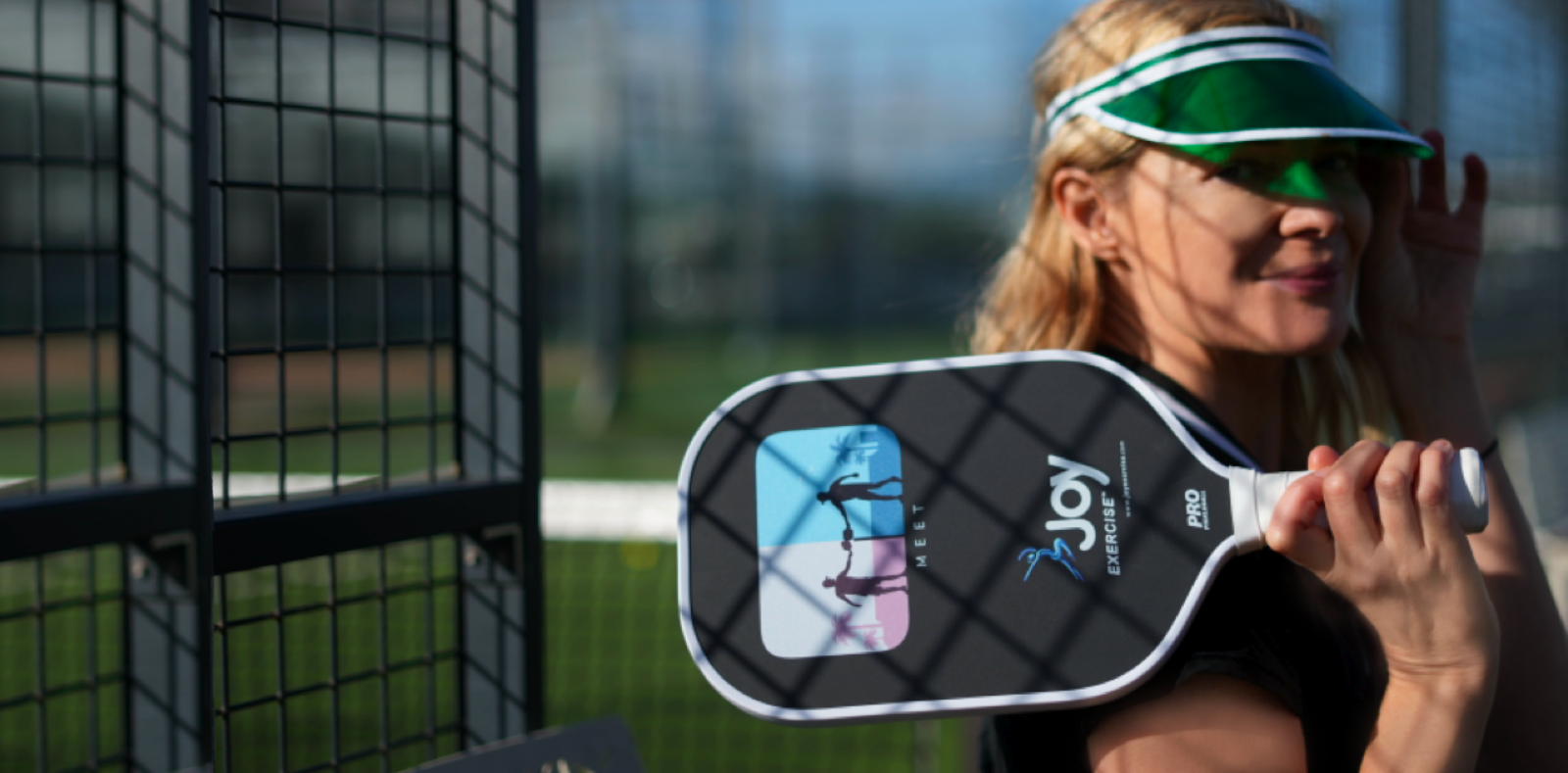 Woman holding a pickleball paddle on a court
